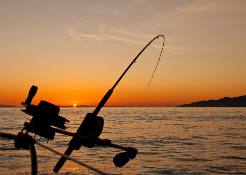 Fishing rig with sunset in background over sea scape